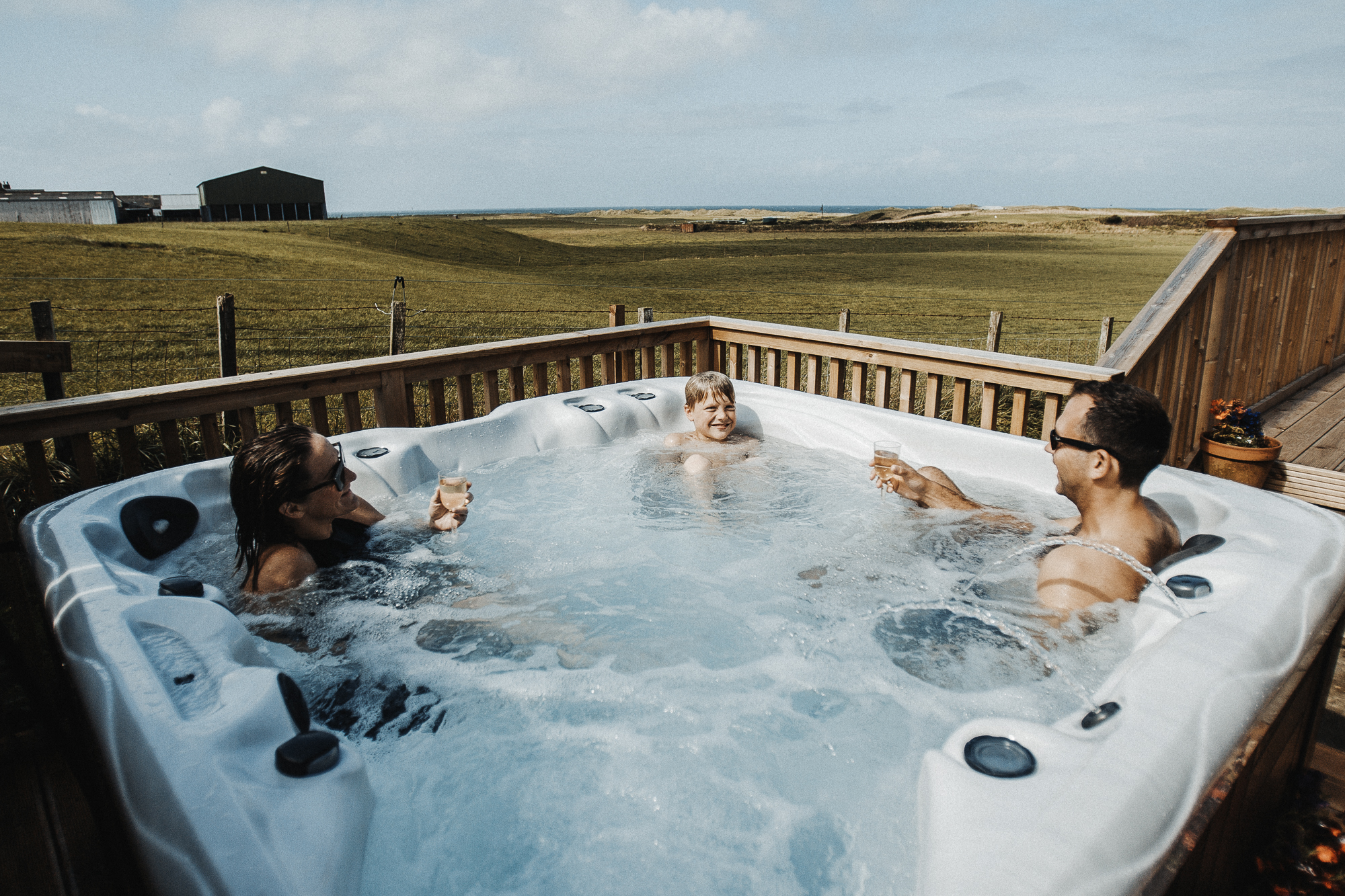 family sitting in hot tub overlooking Machrihanish Holiday Park